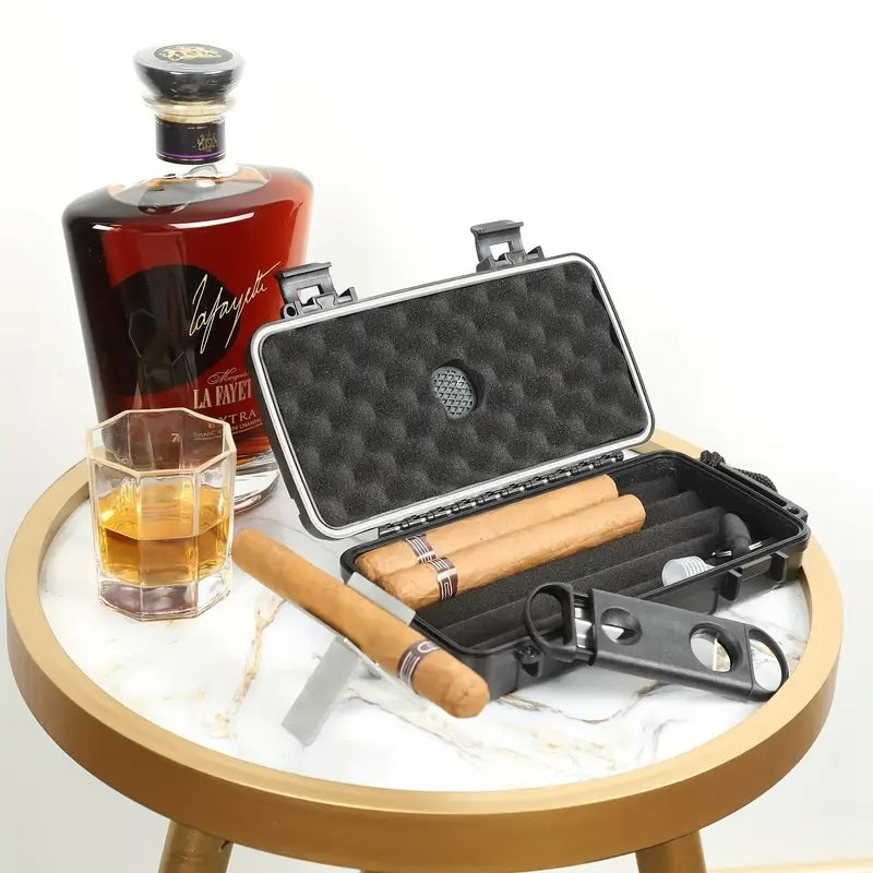 Bottle of Laphroaig whisky, glass with whisky, and open black cigar case on a round wooden table.