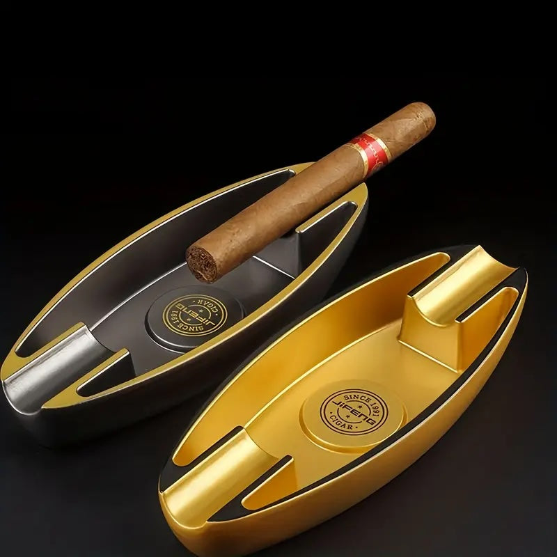 Gold and black cigar ashtray with a cigar on a dark background
