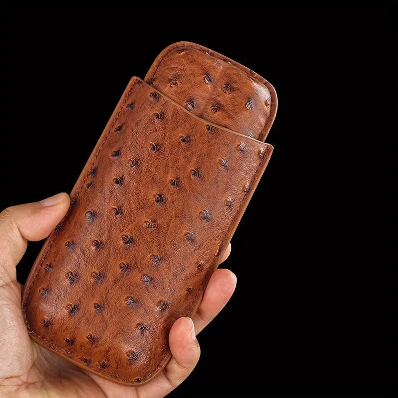 Brown leather case with a textured pattern held in a hand against a black background