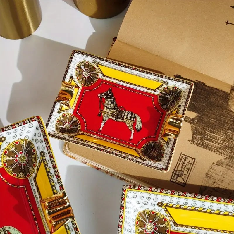 Decorative playing card boxes with a horse design on a white surface.