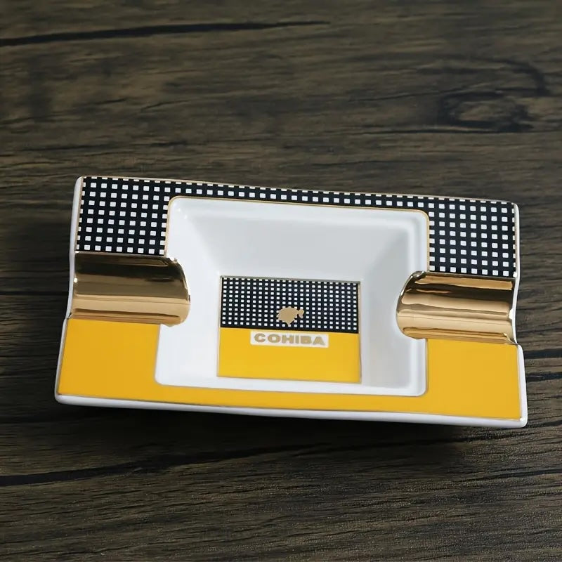 Cohiba branded ashtray with gold accents on a wooden surface