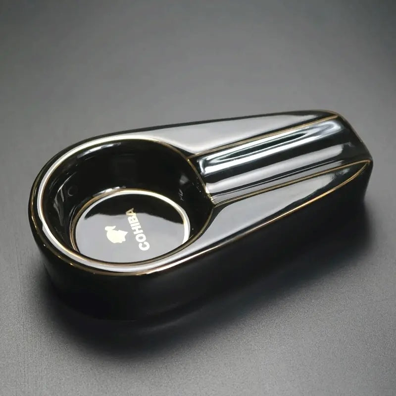 Black and chrome smoking pipe on a gray background