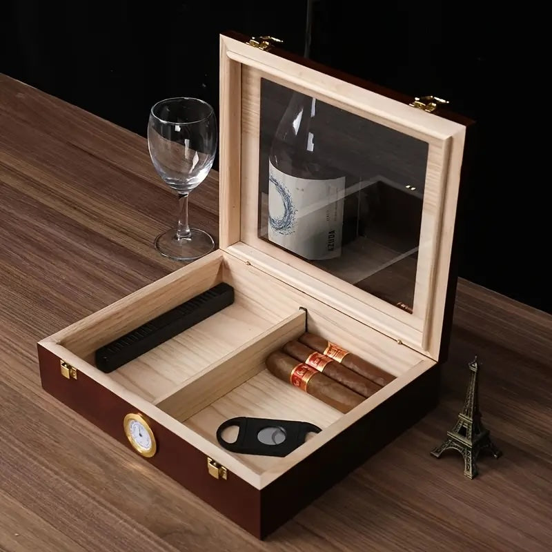 Wooden humidor with cigars, a bottle, and a glass on a wooden surface.